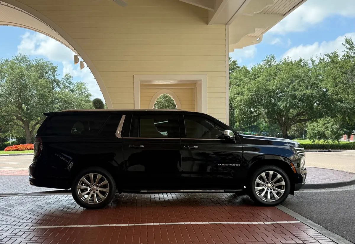 Black Chevrolet Suburban from the Luna Negra fleet under a resort entrance canopy