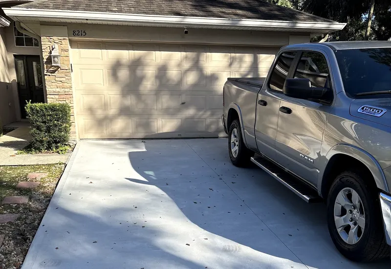 Finished concrete driveway in front of a garage, from a customer's review
