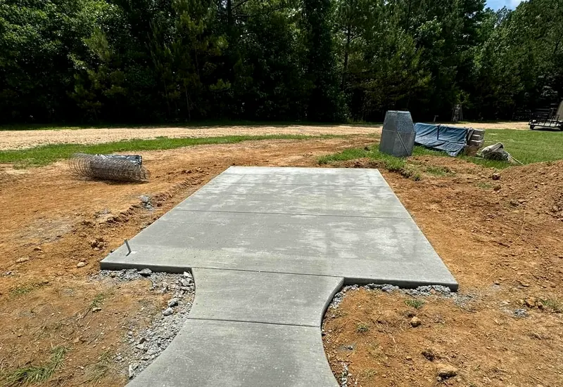 Concrete walkway leading to a poured pad