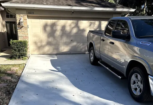 Finished concrete driveway in front of a garage, from a customer's review