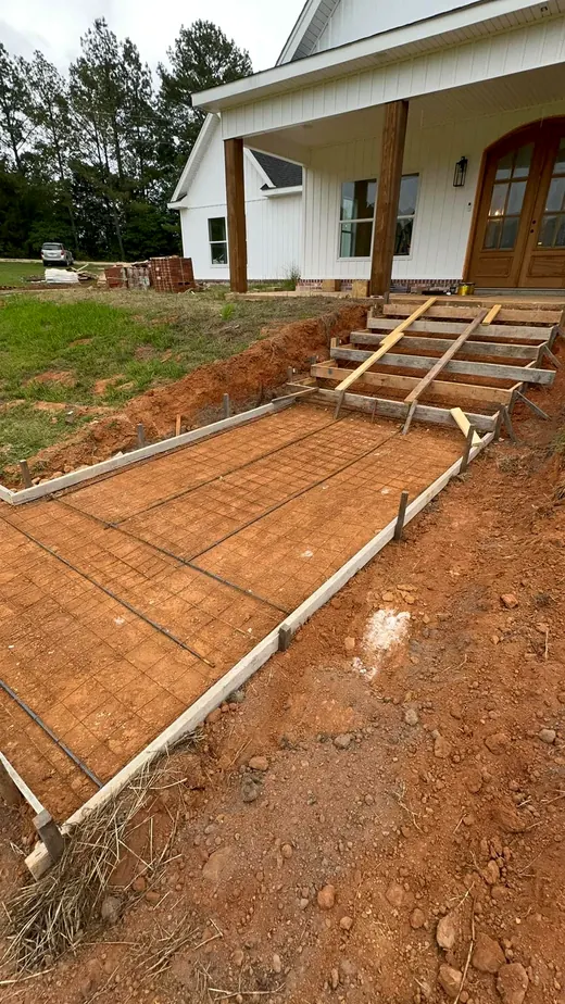 Entry pad formed with rebar and ready for the pour at a white farmhouse