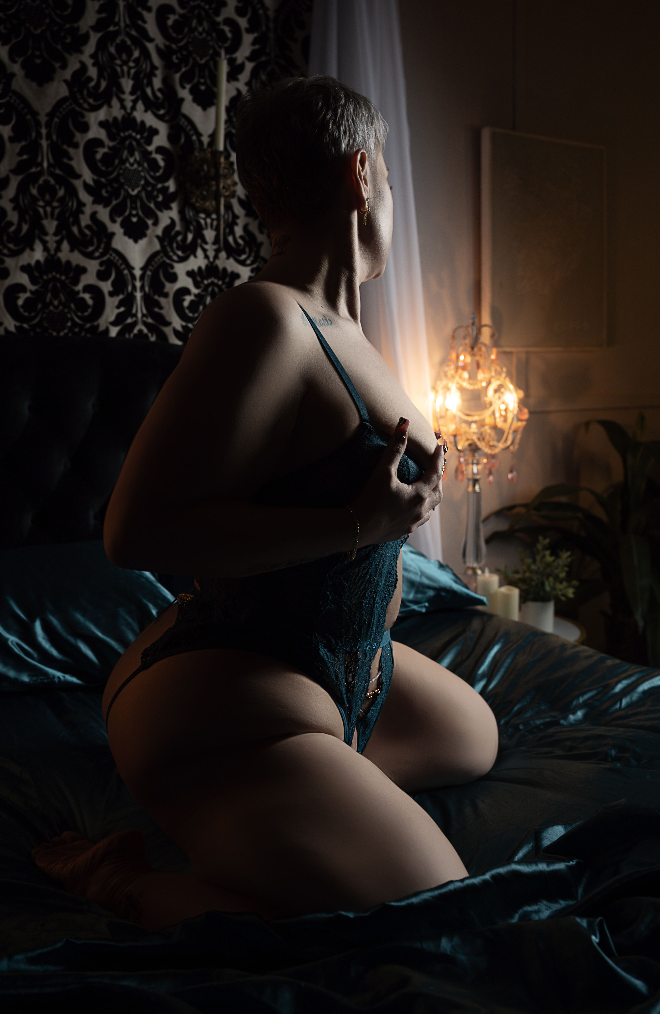 Amanda Marquis Plus Size Boudoir client in bodysuit, seated pose
