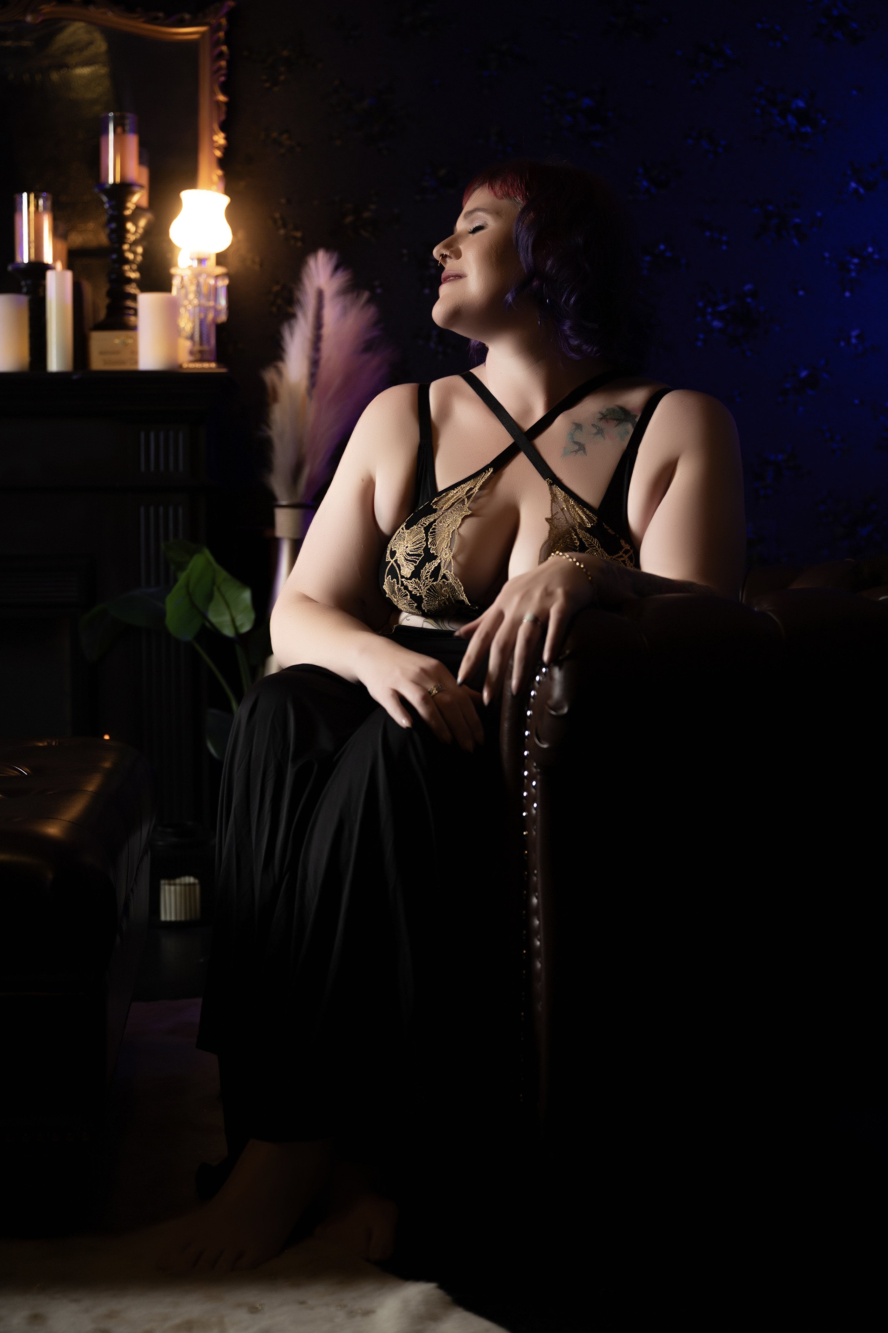 Plus size boudoir client with confident expression during a guided session with Amanda Marquis Photography