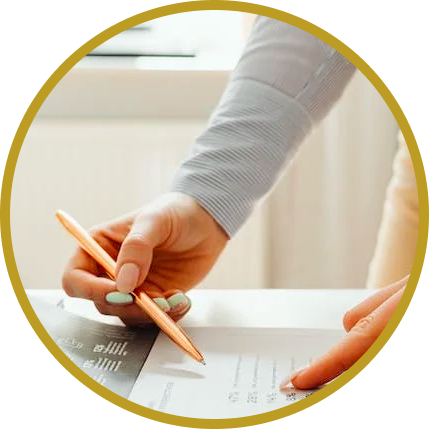 Woman holding pen on paper at desk