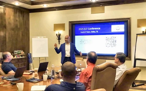Reggie Carney presenting to a leadership team around a conference table