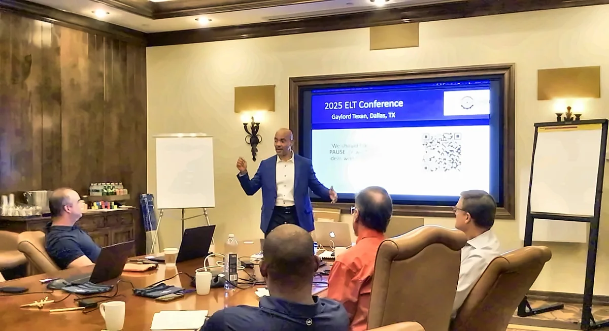 Reggie Carney presenting strategy to leaders around a conference table