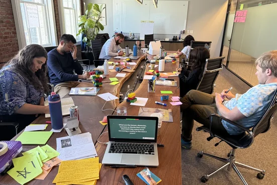 Leaders working together at a strategy retreat table