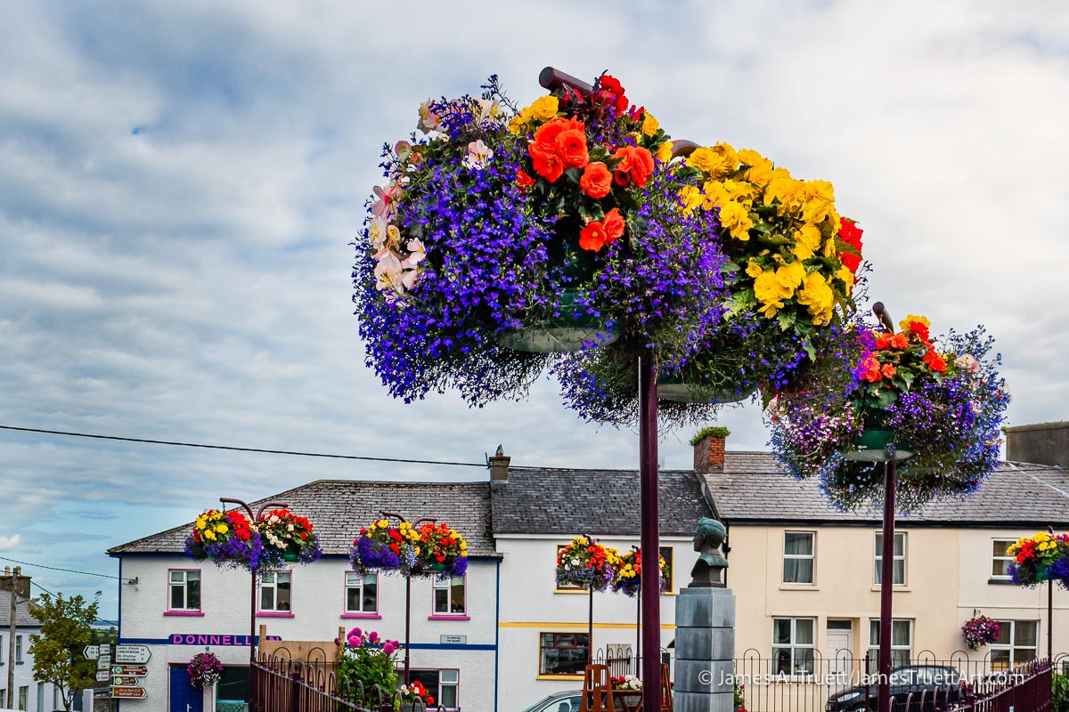 Hanging flower baskets decorate Kildysart Village Square.
