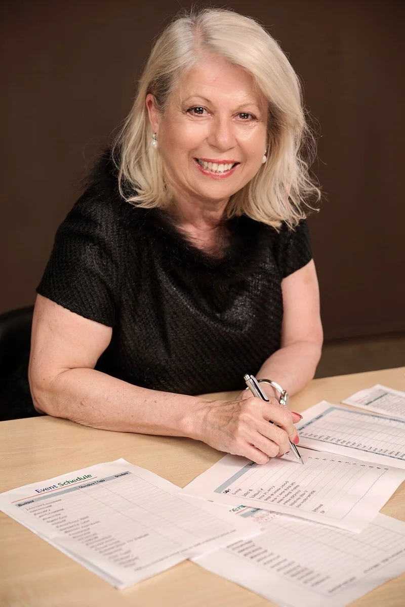 Connie Paglianiti at her desk working on event schedules
