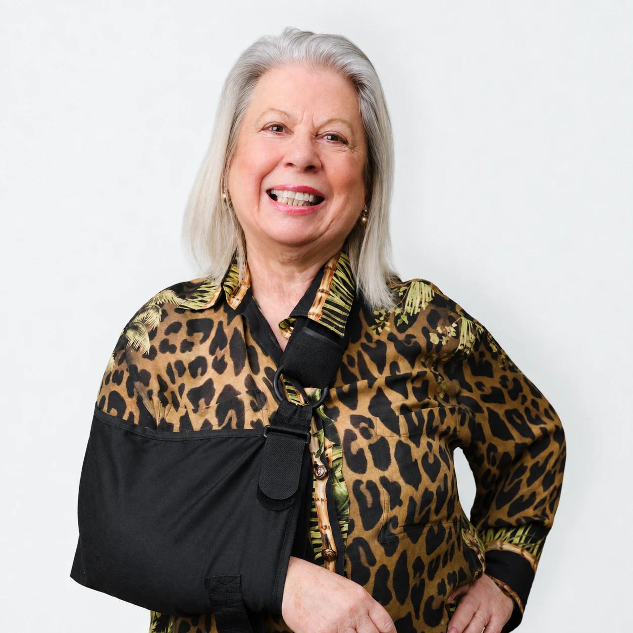 Connie Paglianiti smiling in a gold and black patterned blouse
