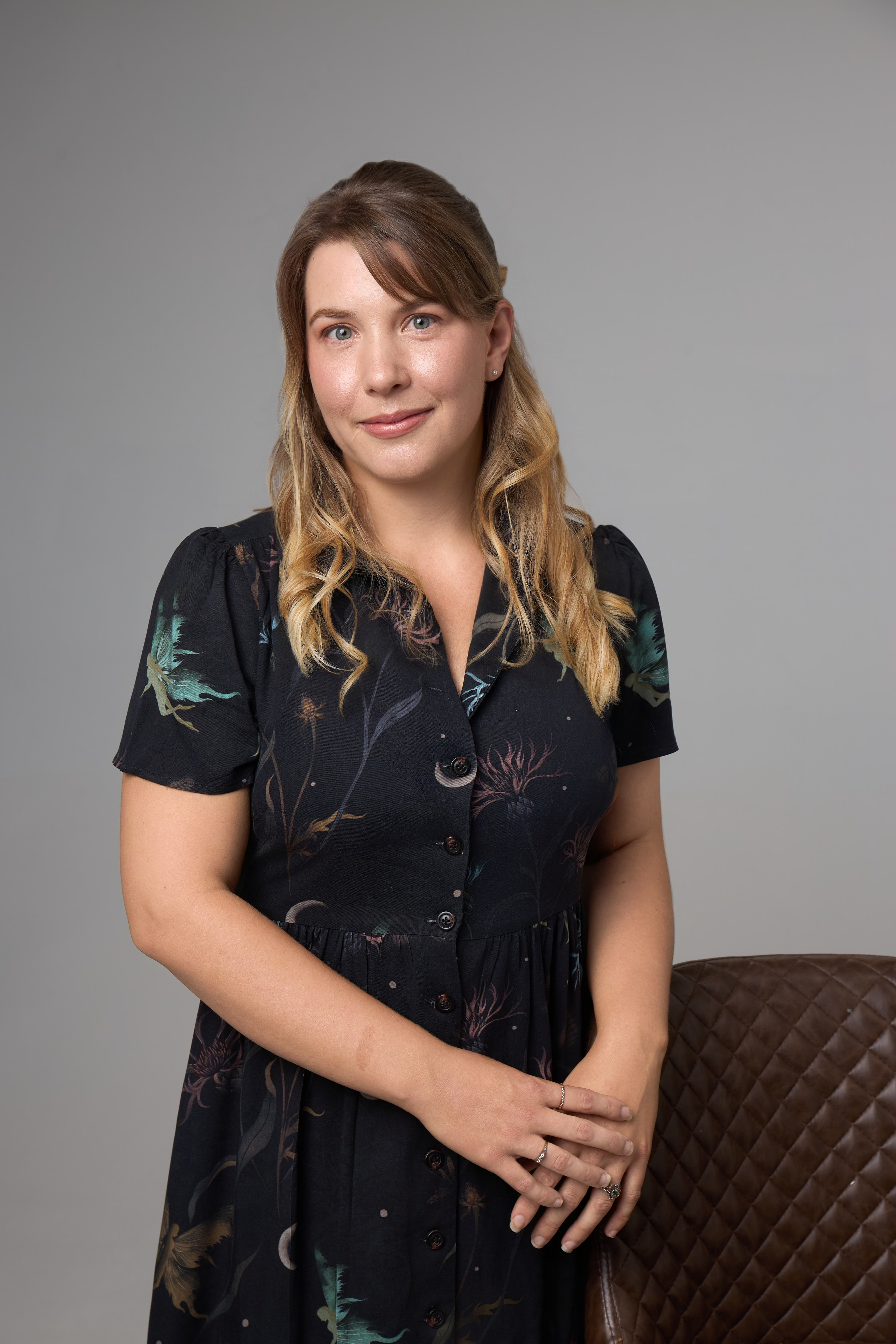 Portrait of Steph Ashington, Children's Wellbeing Consultant, outdoors among wild grasses