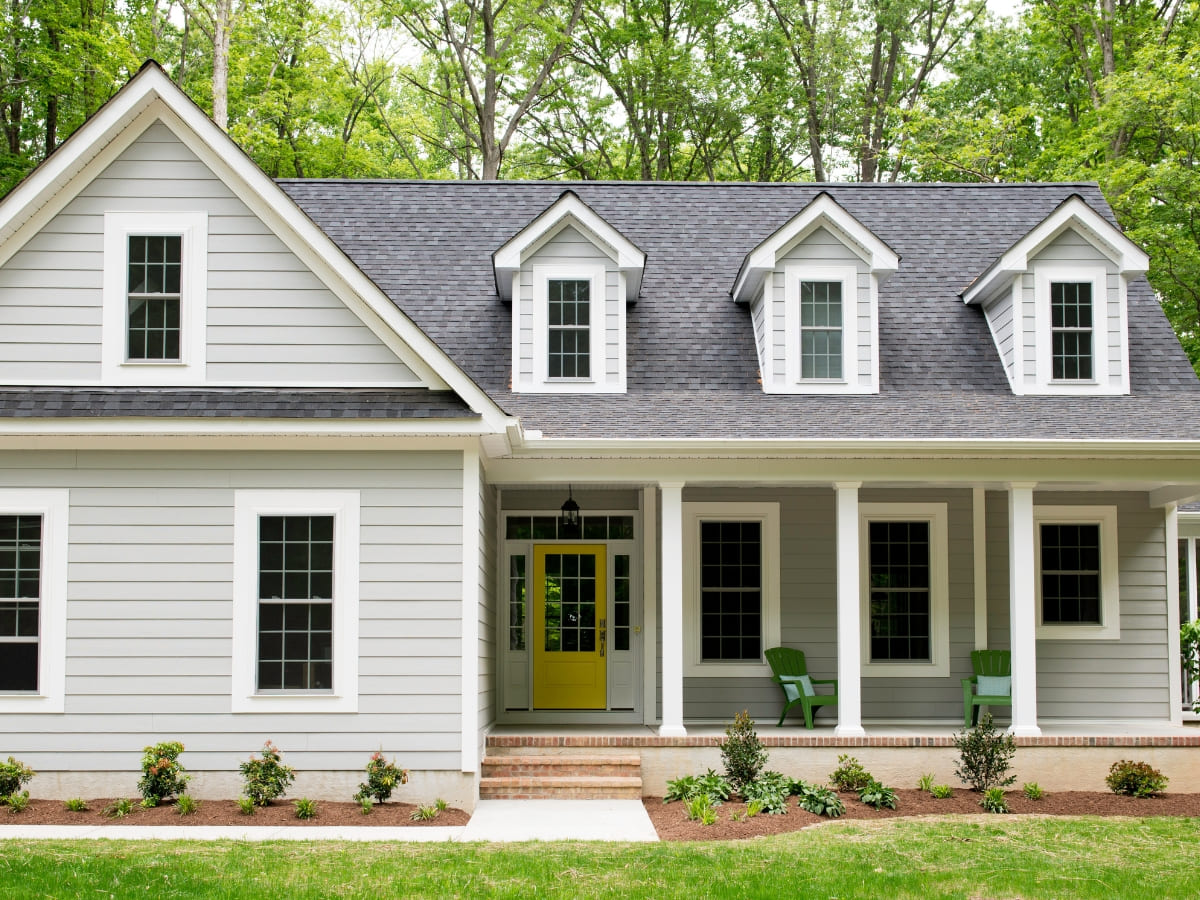 Grey house exterior with waterproofed siding, showcasing effective water protection measures for long-term durability.