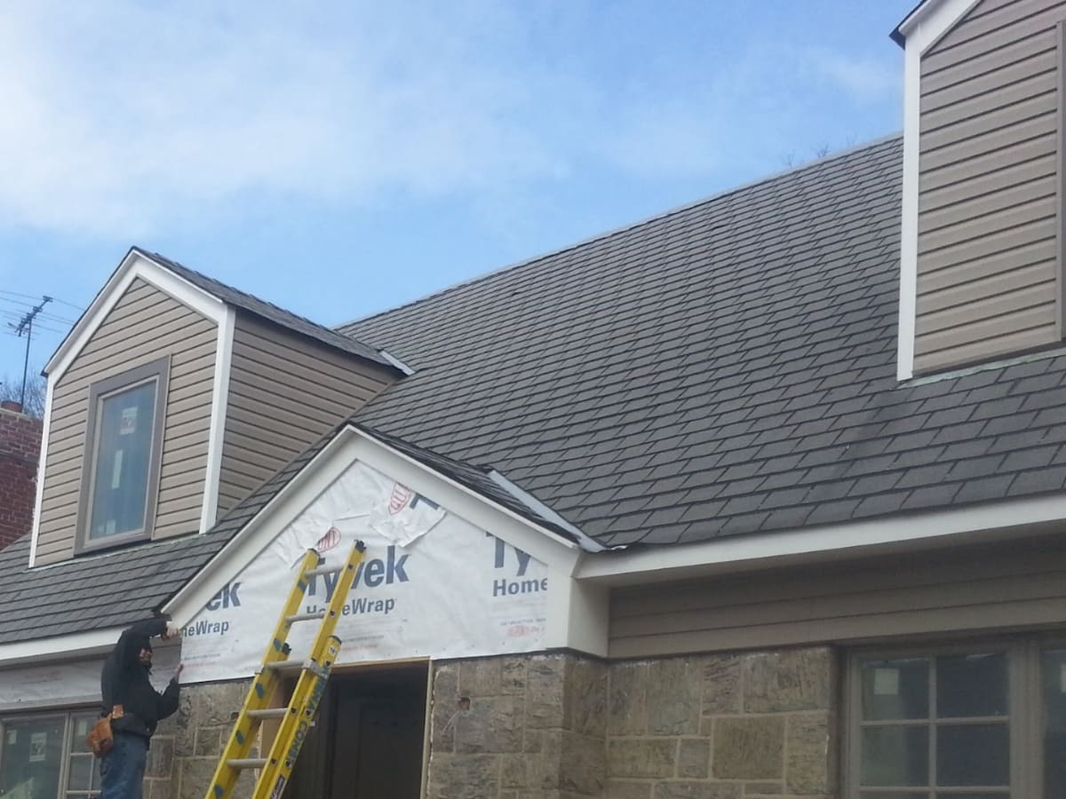 Roof installation in progress, highlighting waterproofing underlayment and new shingles.