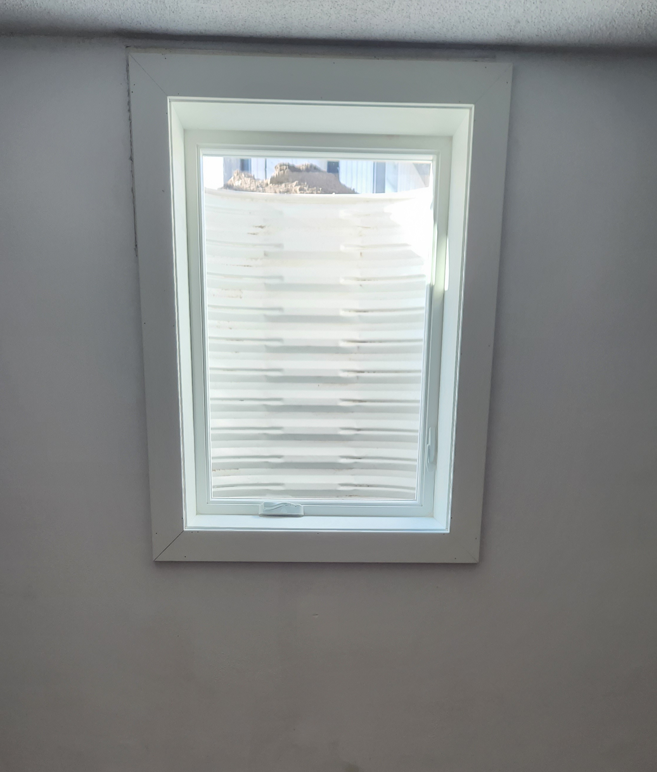 Egress window viewed from inside a finished basement room