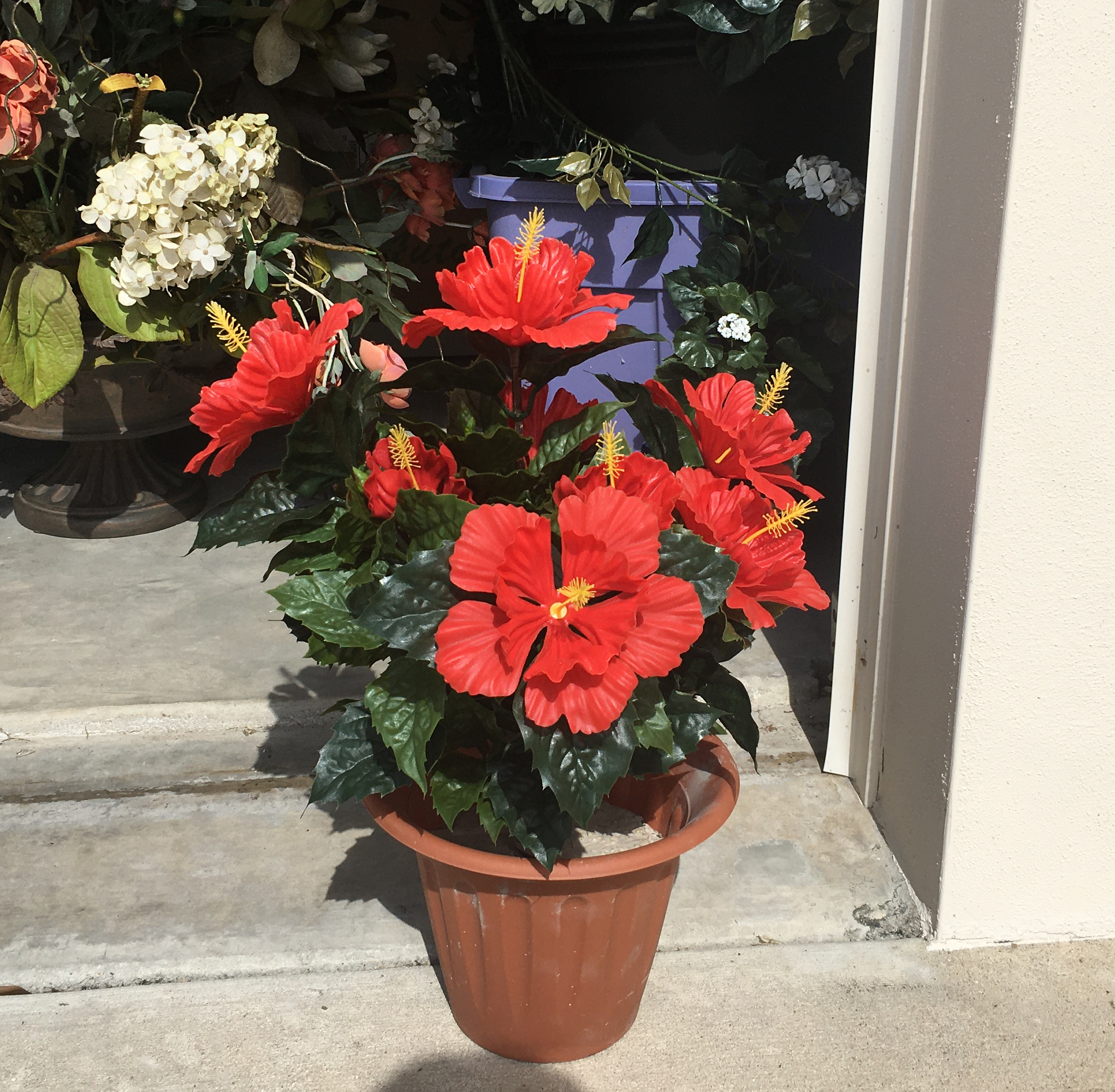 Red artificial outdoor hibiscus in planter