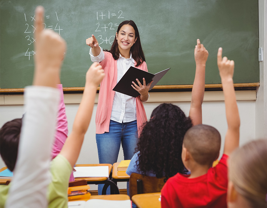 Teacher helping student in classroom