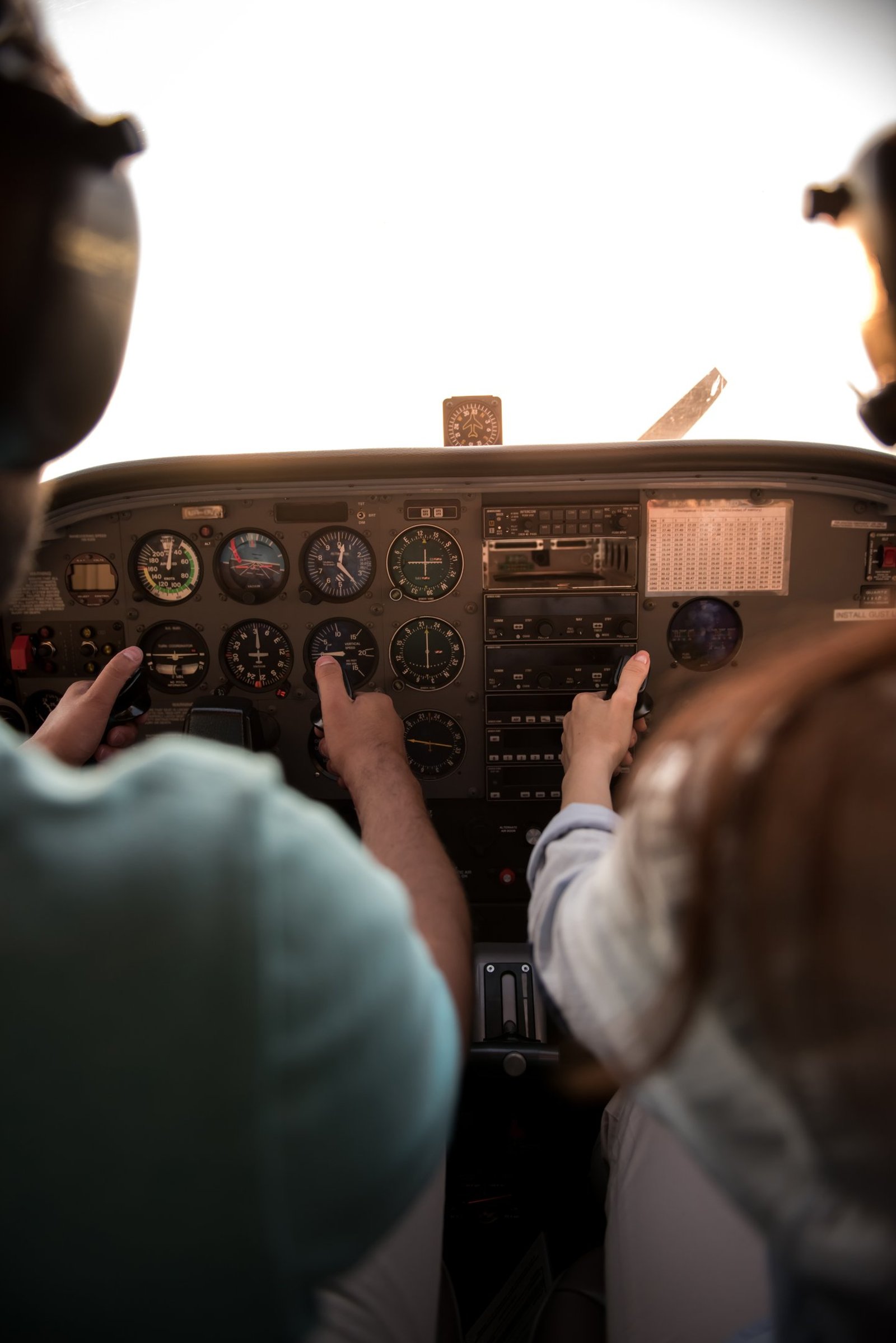 Student pilot and flight instructor at the controls of a Piper