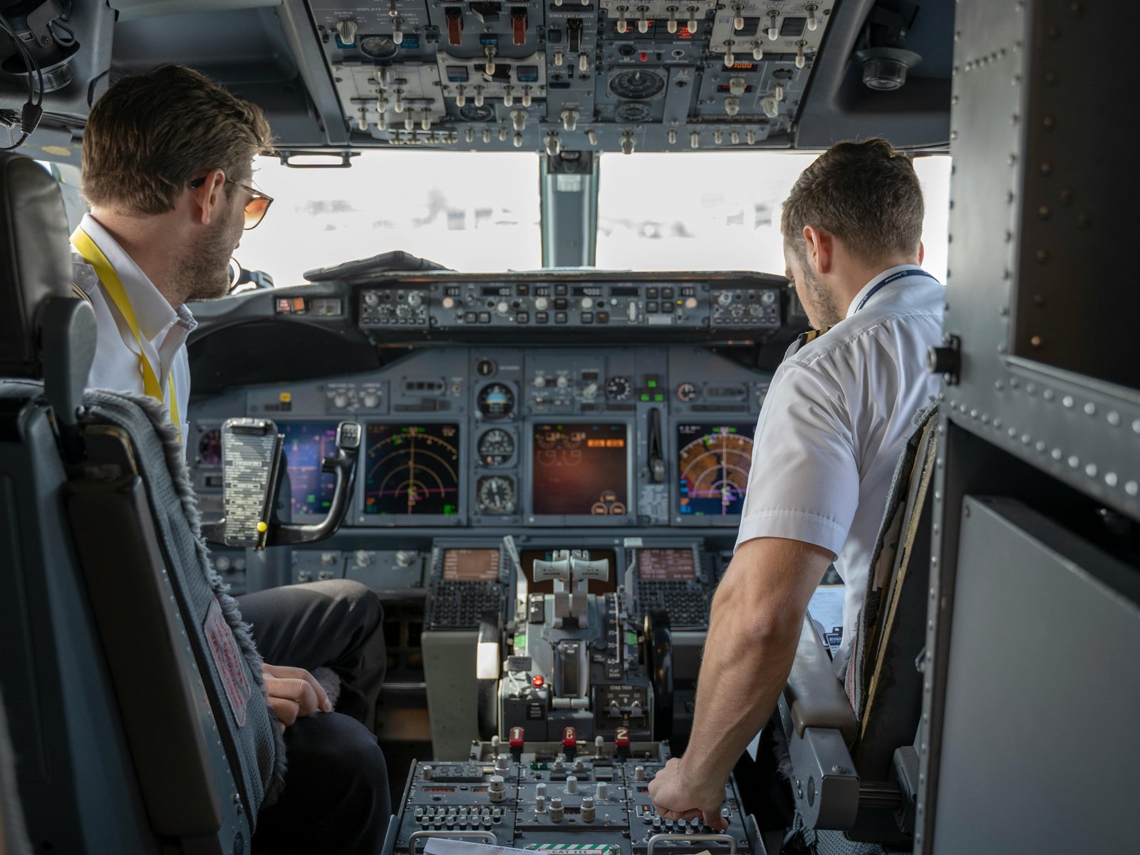 Two pilots in an airliner cockpit