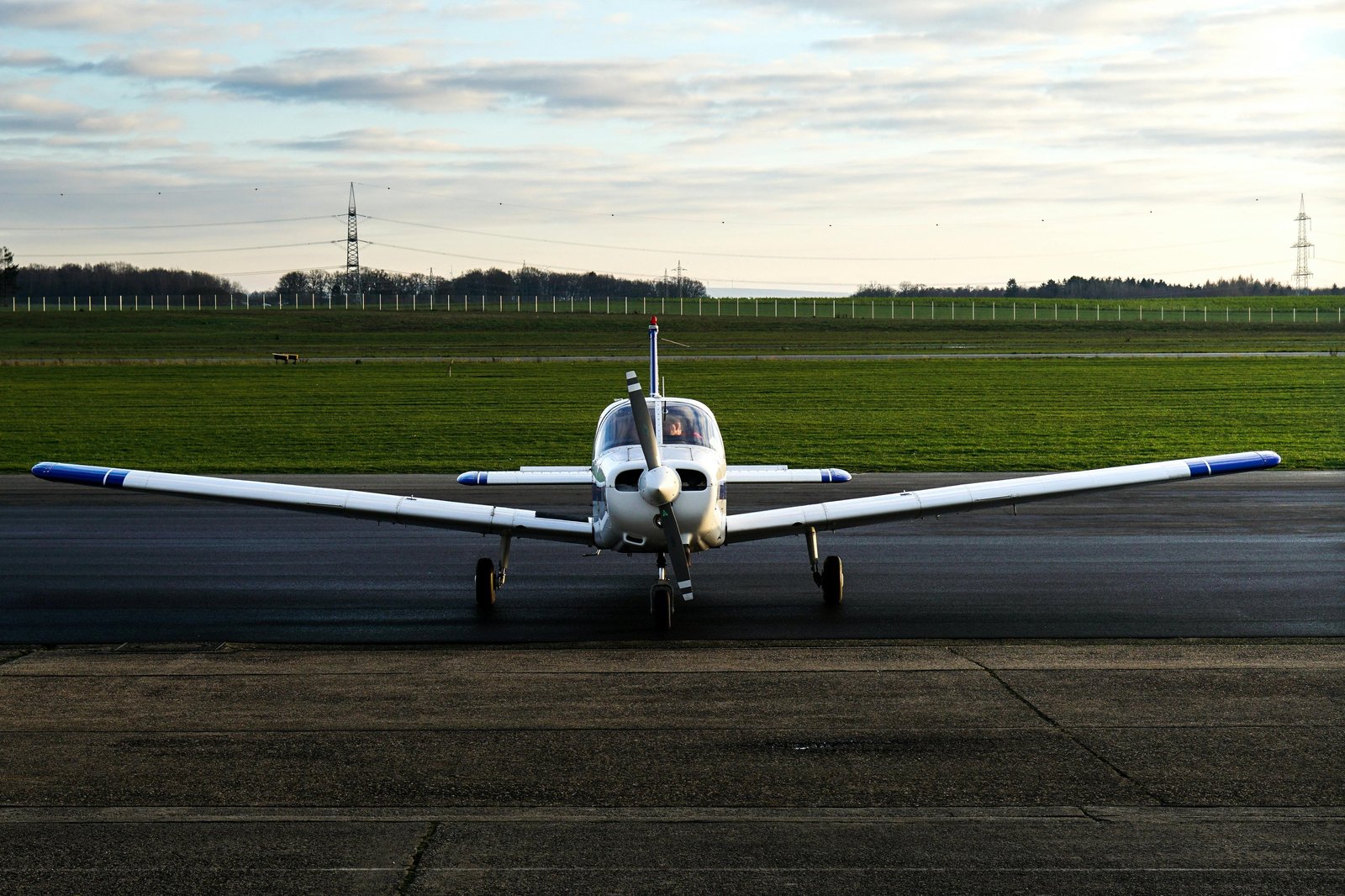 Piper Cherokee training aircraft taxiing on the ramp