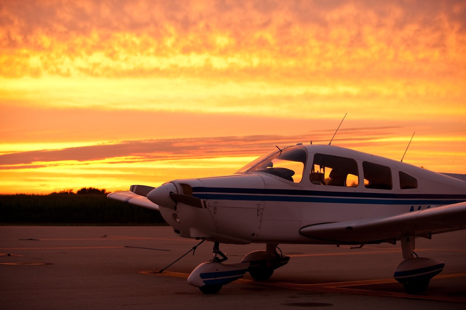 Piper Cherokee on the ramp at sunset