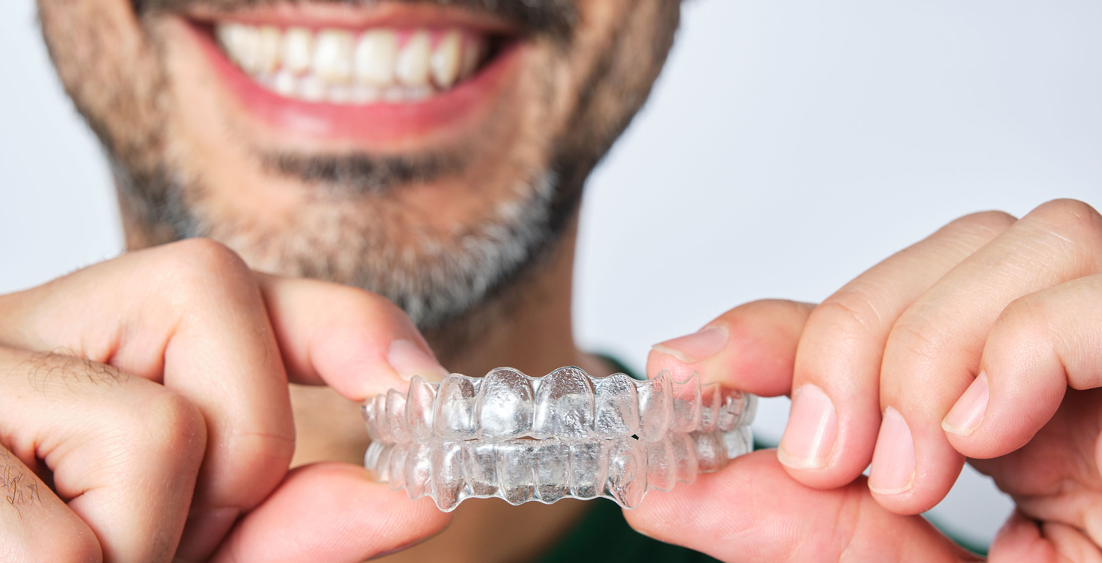 Woman holding invisalign