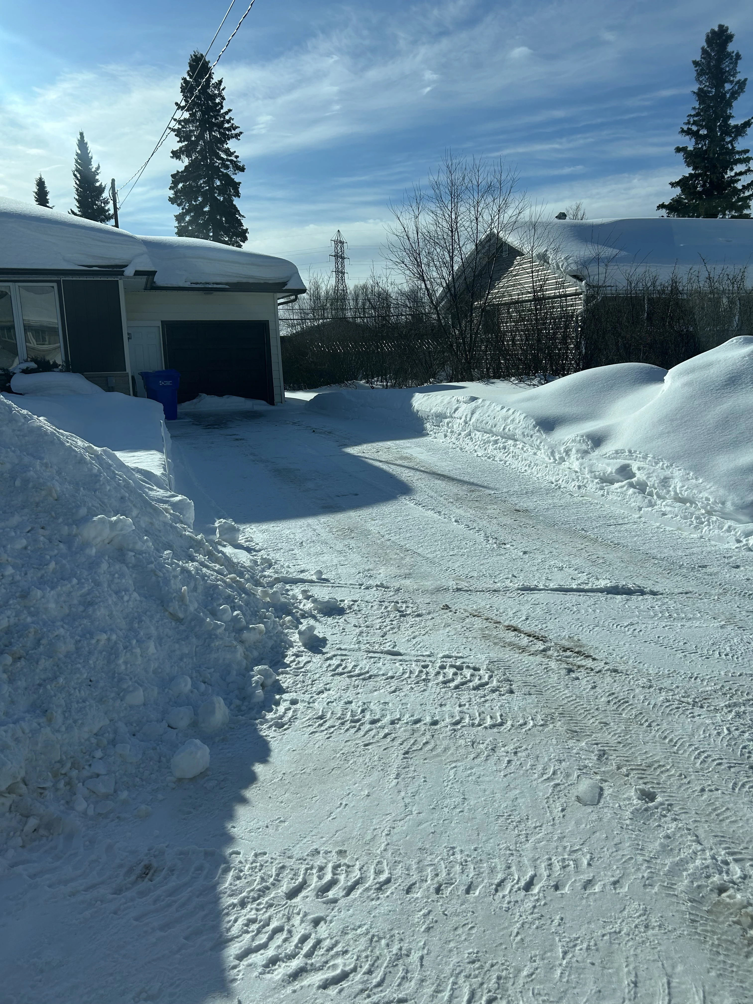 Professional snow plowing service clearing driveway in Kirkland Lake, Ontario