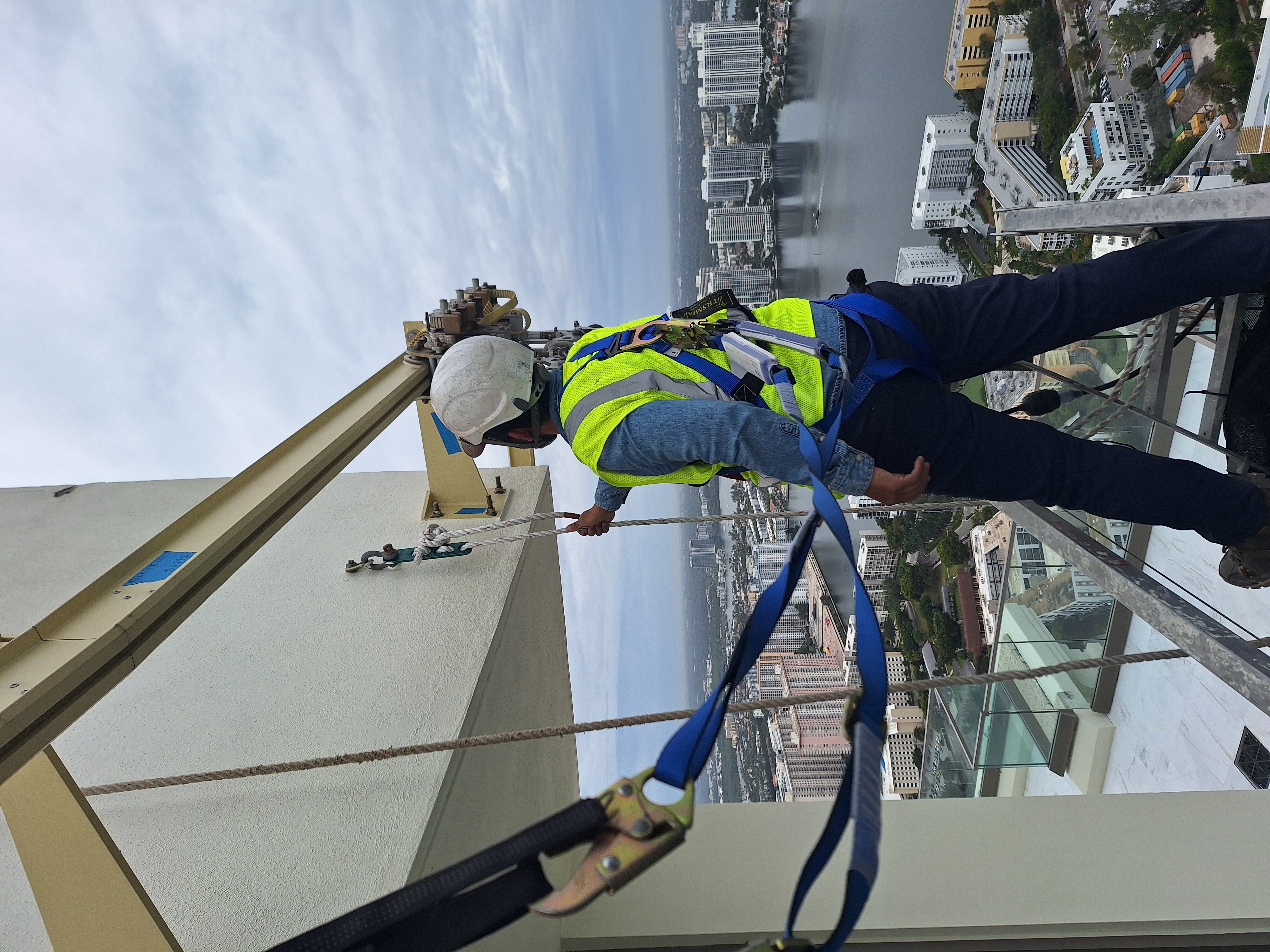 Rope access crew performing aerial operations on high-rise building