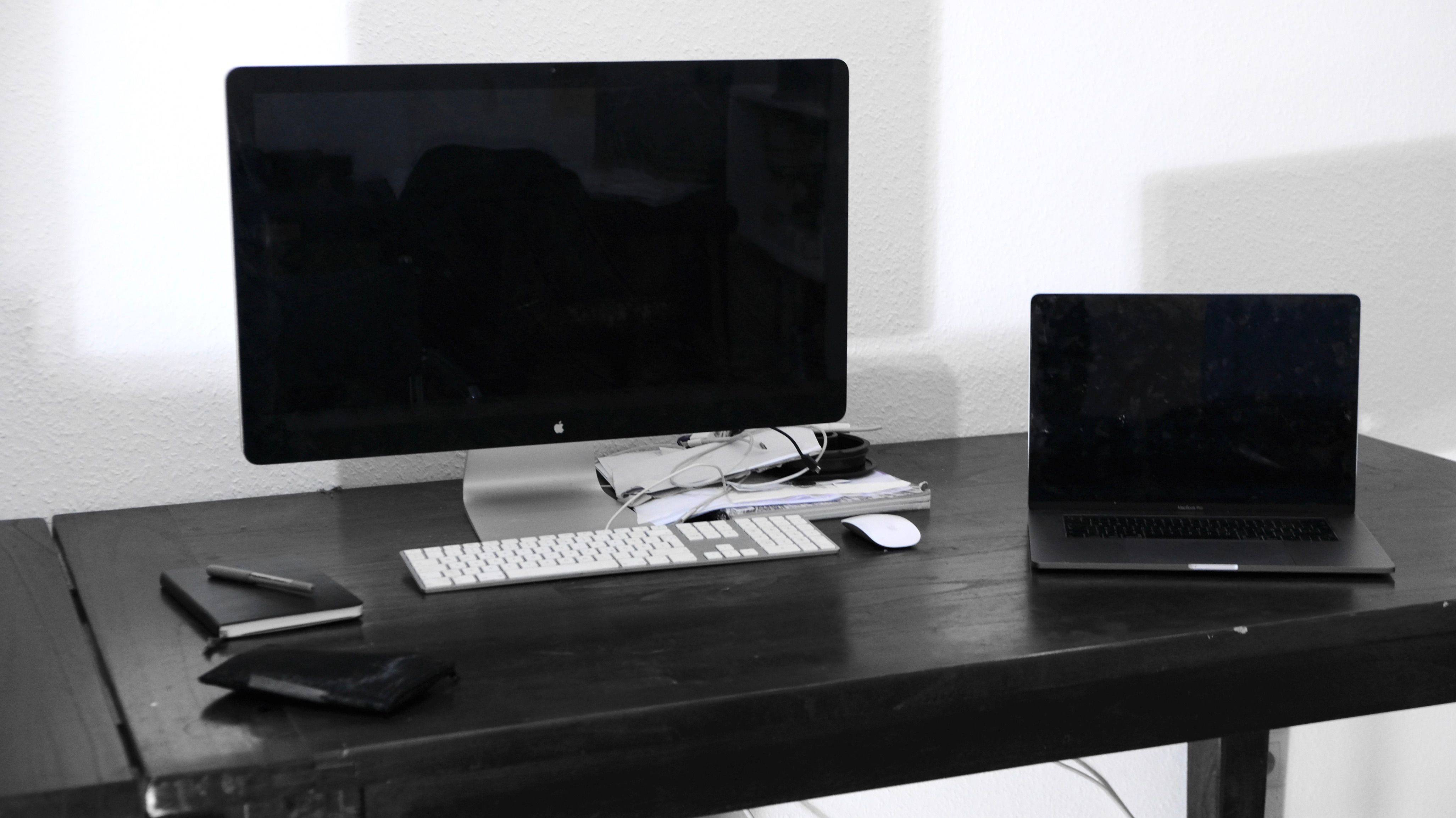 modern computer and laptop on table in room