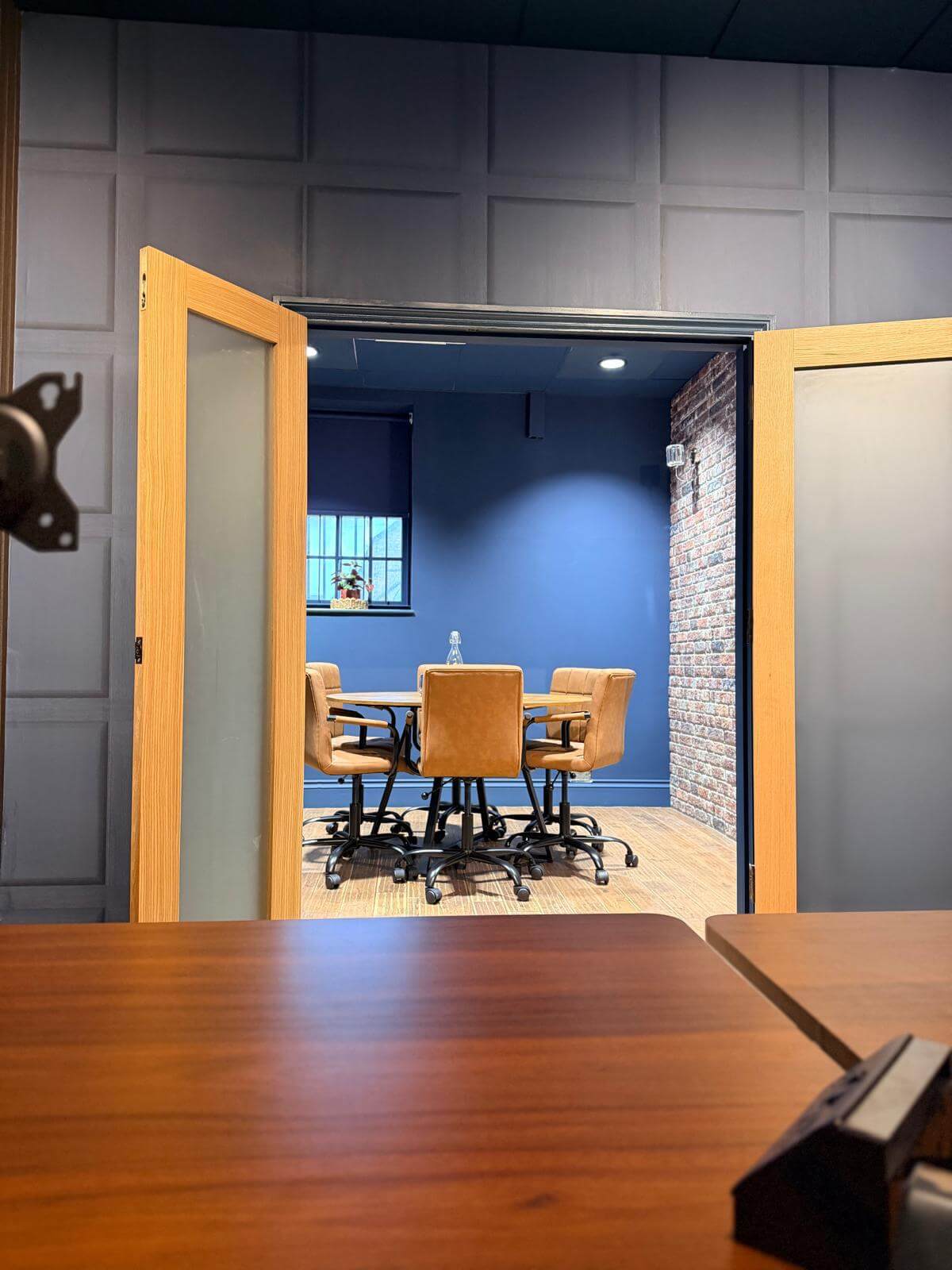 Looking through the open doors from a desk at Olney Workspace into the meeting room
