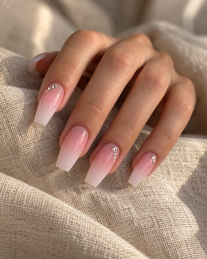 Soft pink ombre coffin nails with rhinestones