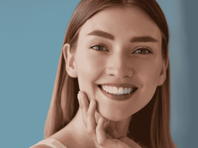 a woman smiling, showing white teeth a woman smiling, showing white teeth