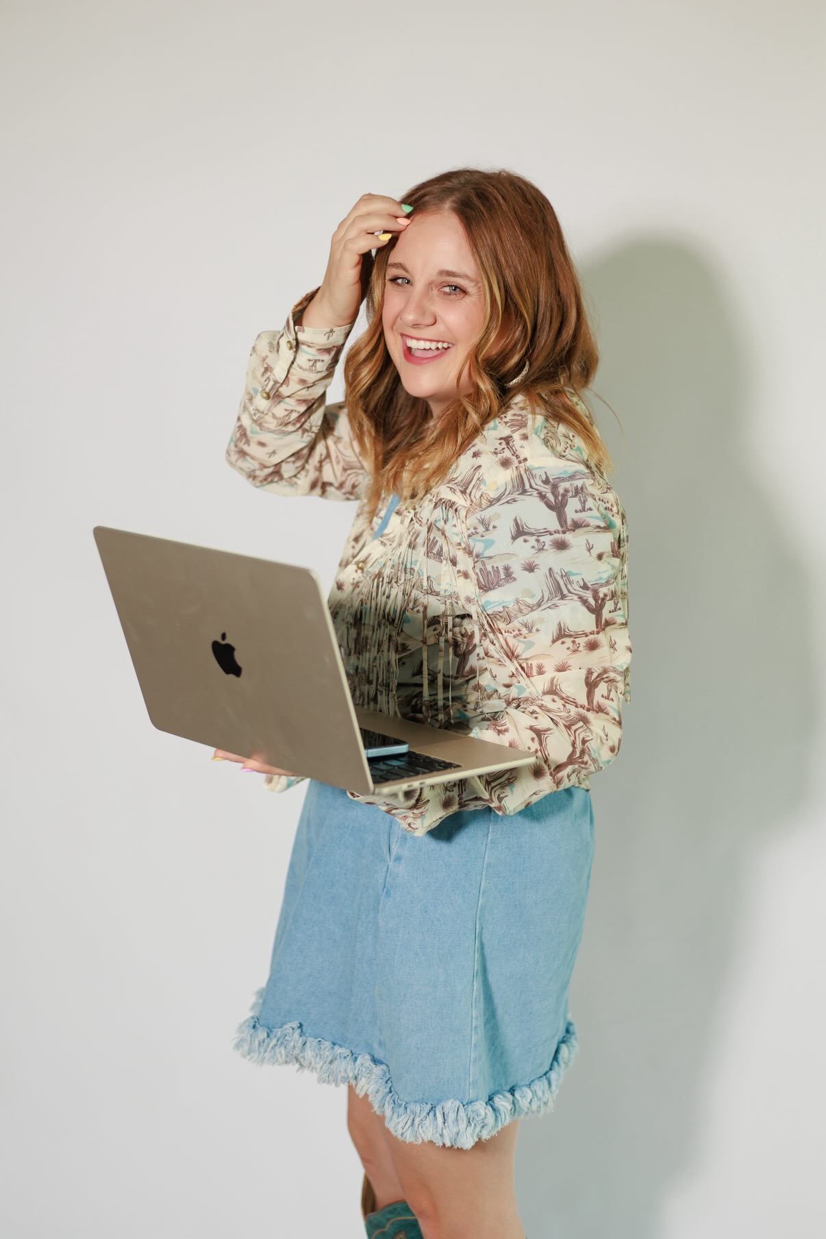 Callie Wagner smiling and holding laptop