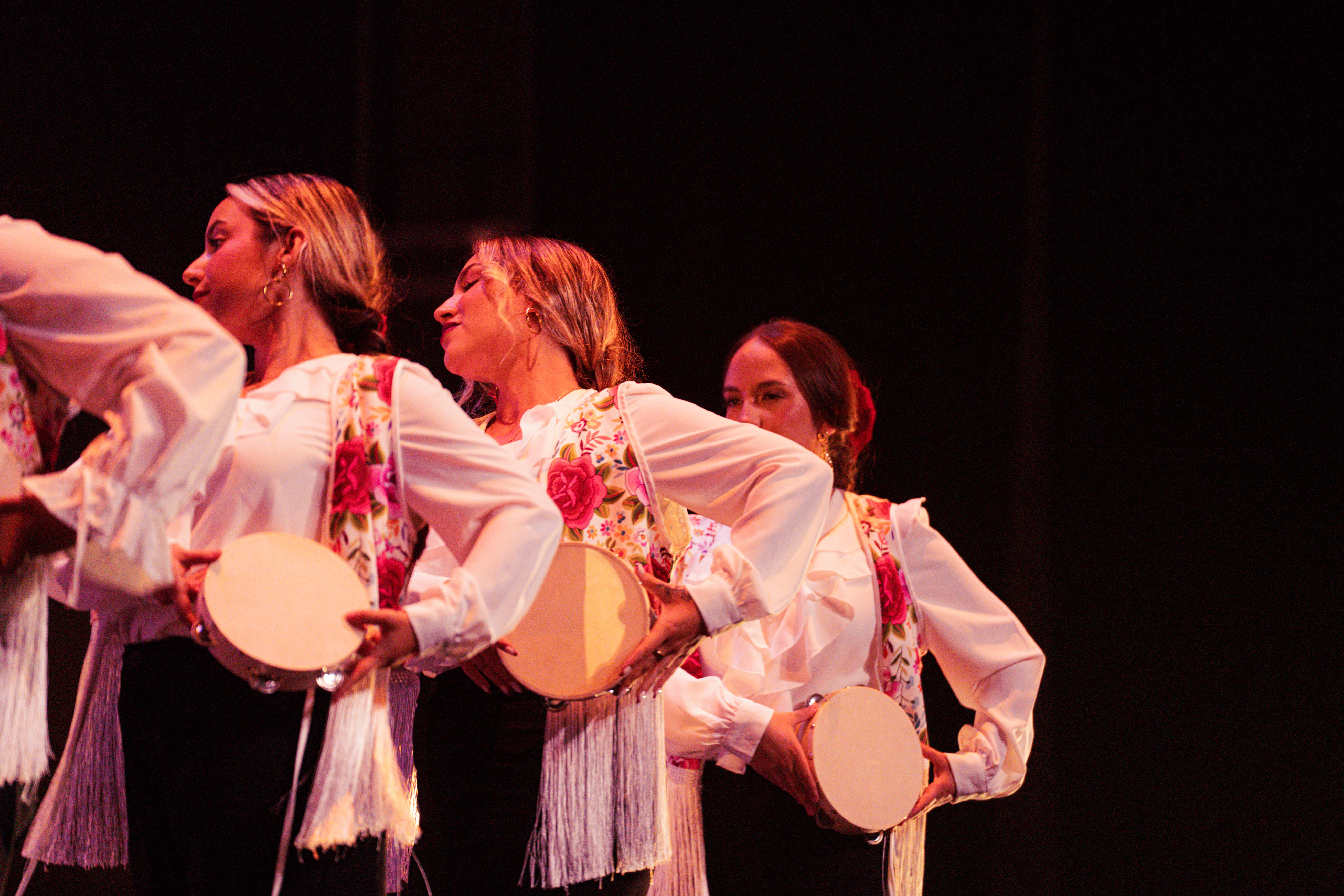 Alumnas de A RITMO tocando la pandereta en el escenario