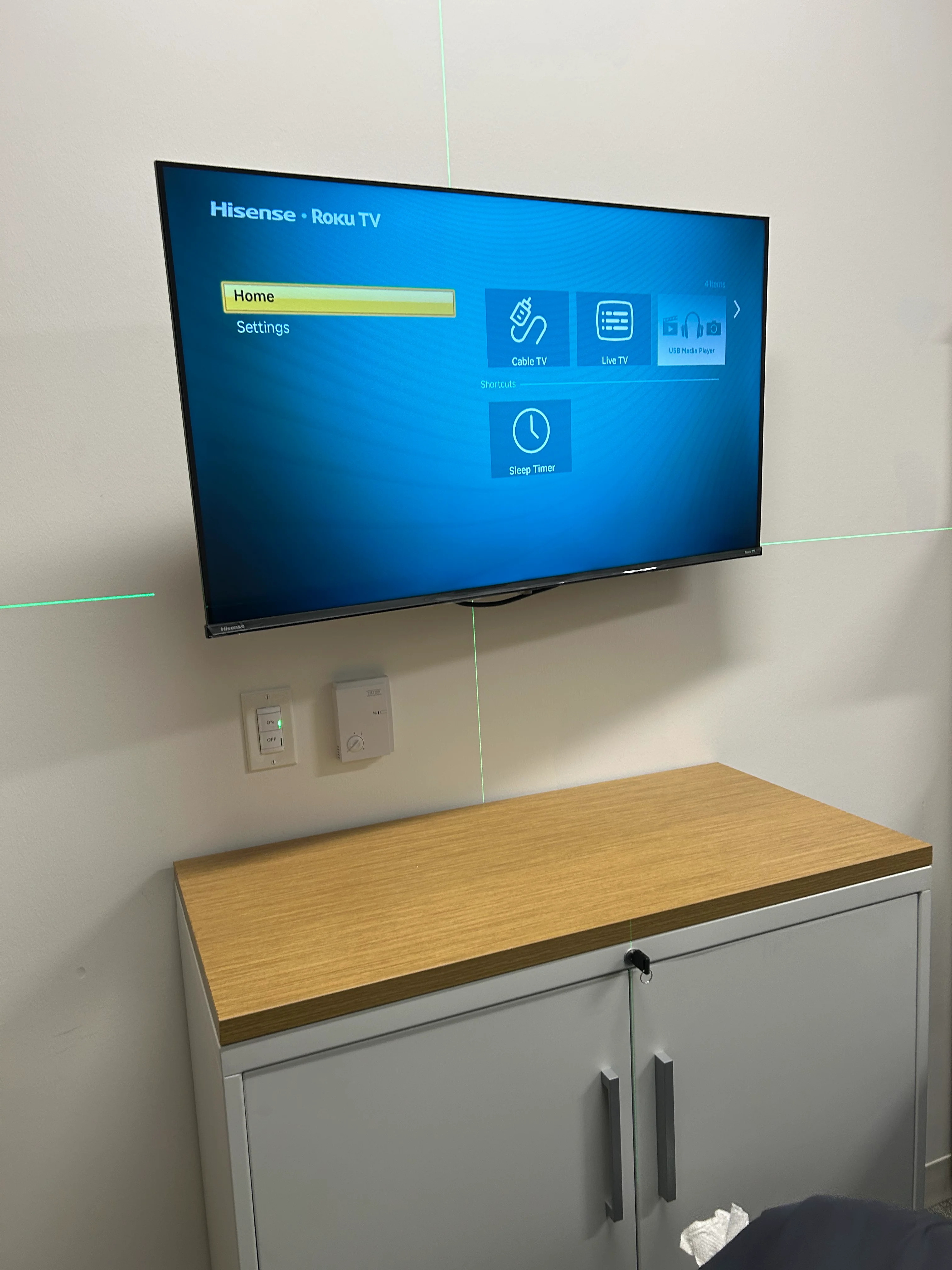 A Hisense Roku TV displaying its home menu with options for Live TV, Cable TV, USB Media Player, and Sleep Timer.