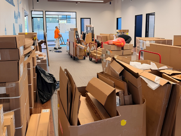 commercial furniture storage and warehousing with labeled boxes and office equipment during business relocation