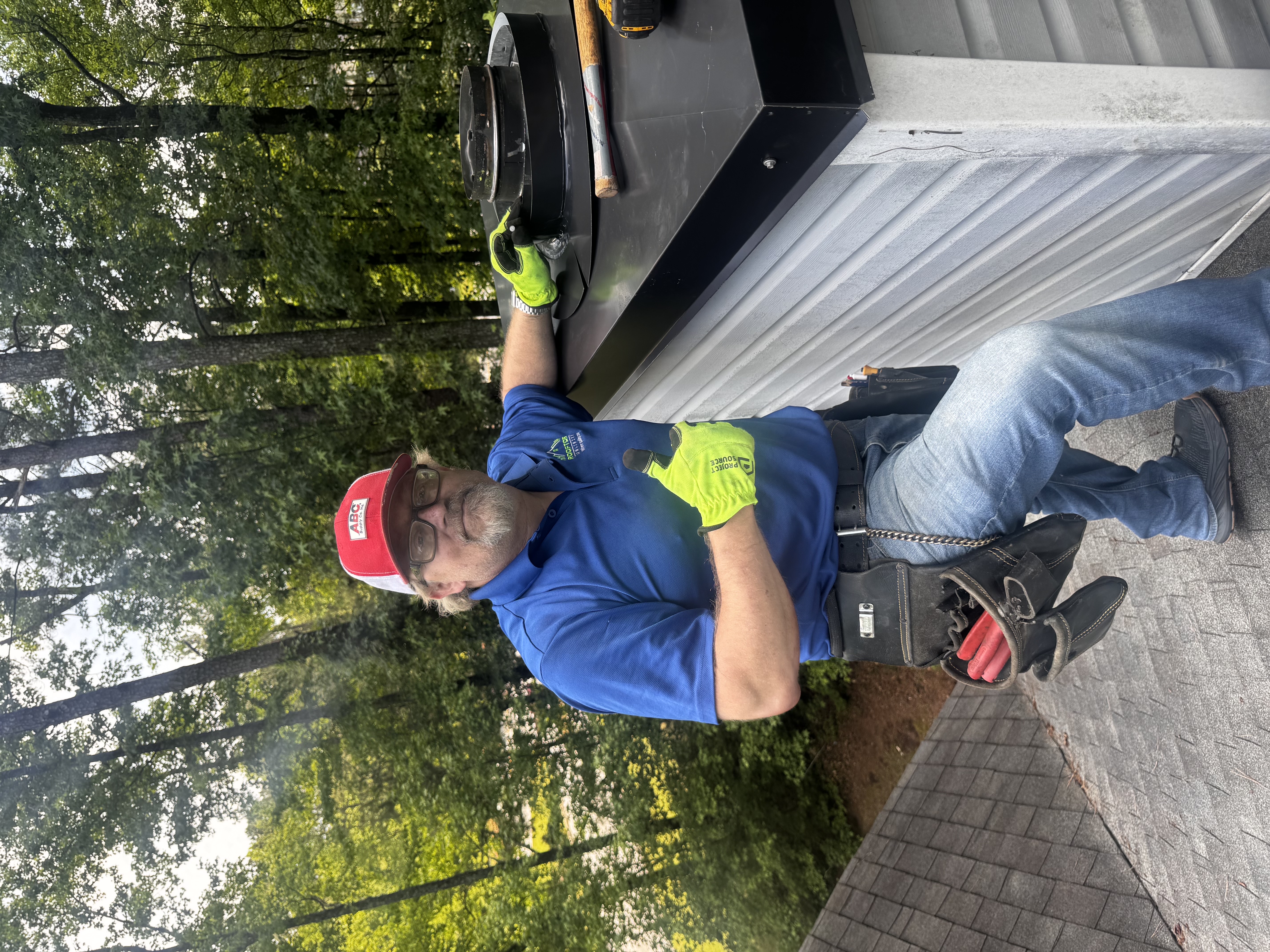 Chimney cap replacement in progress on residential roof - Rooftops Unlimited