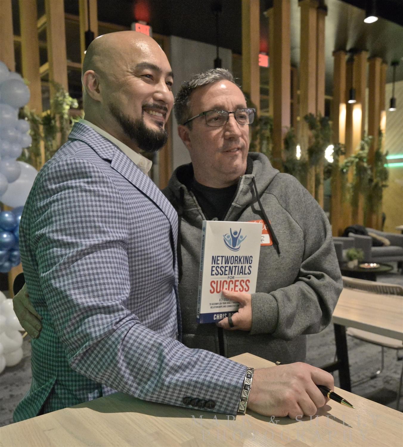 Chris Borja with a reader of Networking Essentials for Success