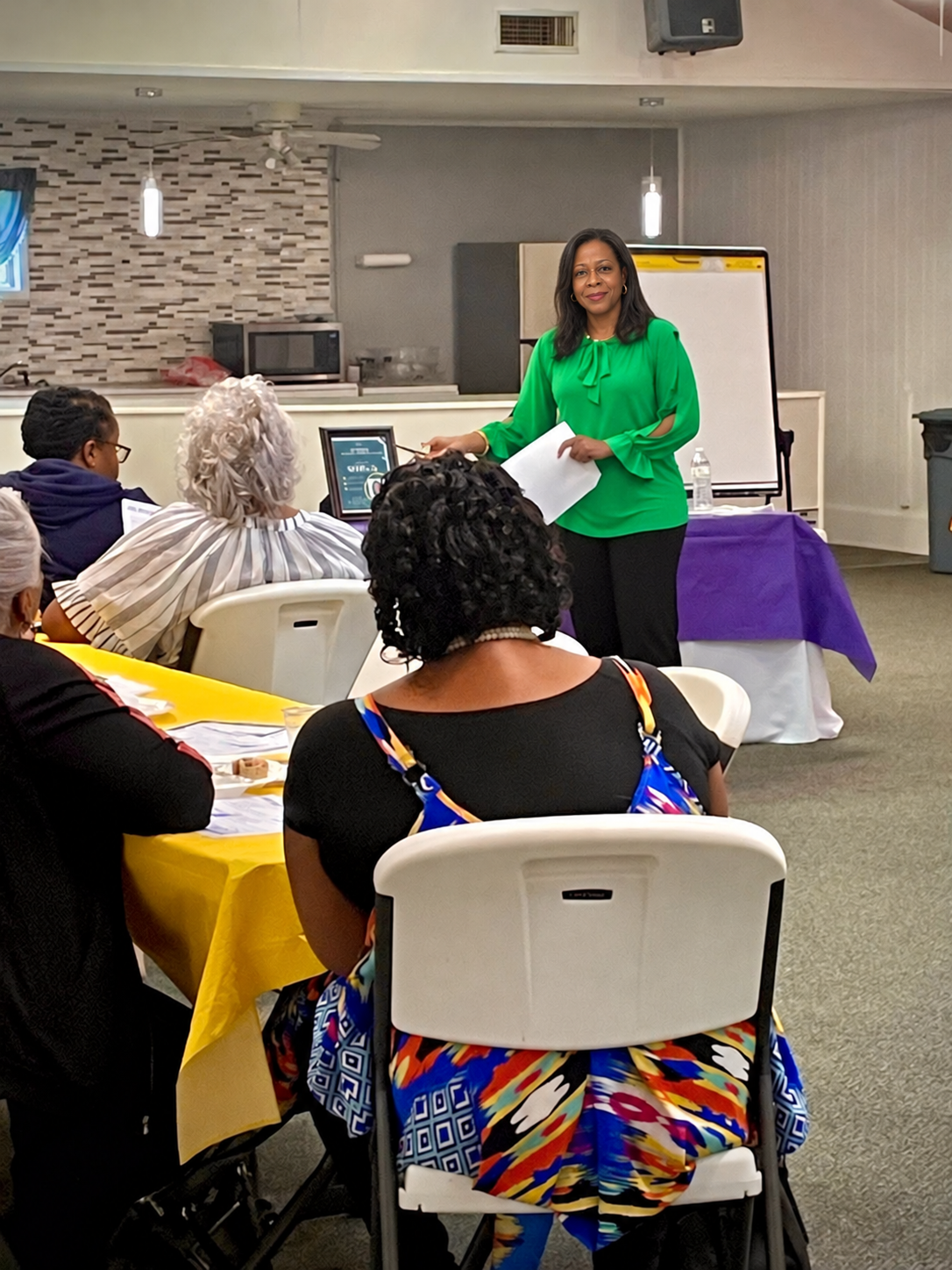 Tinisha teaching a small group with attendees in the foreground