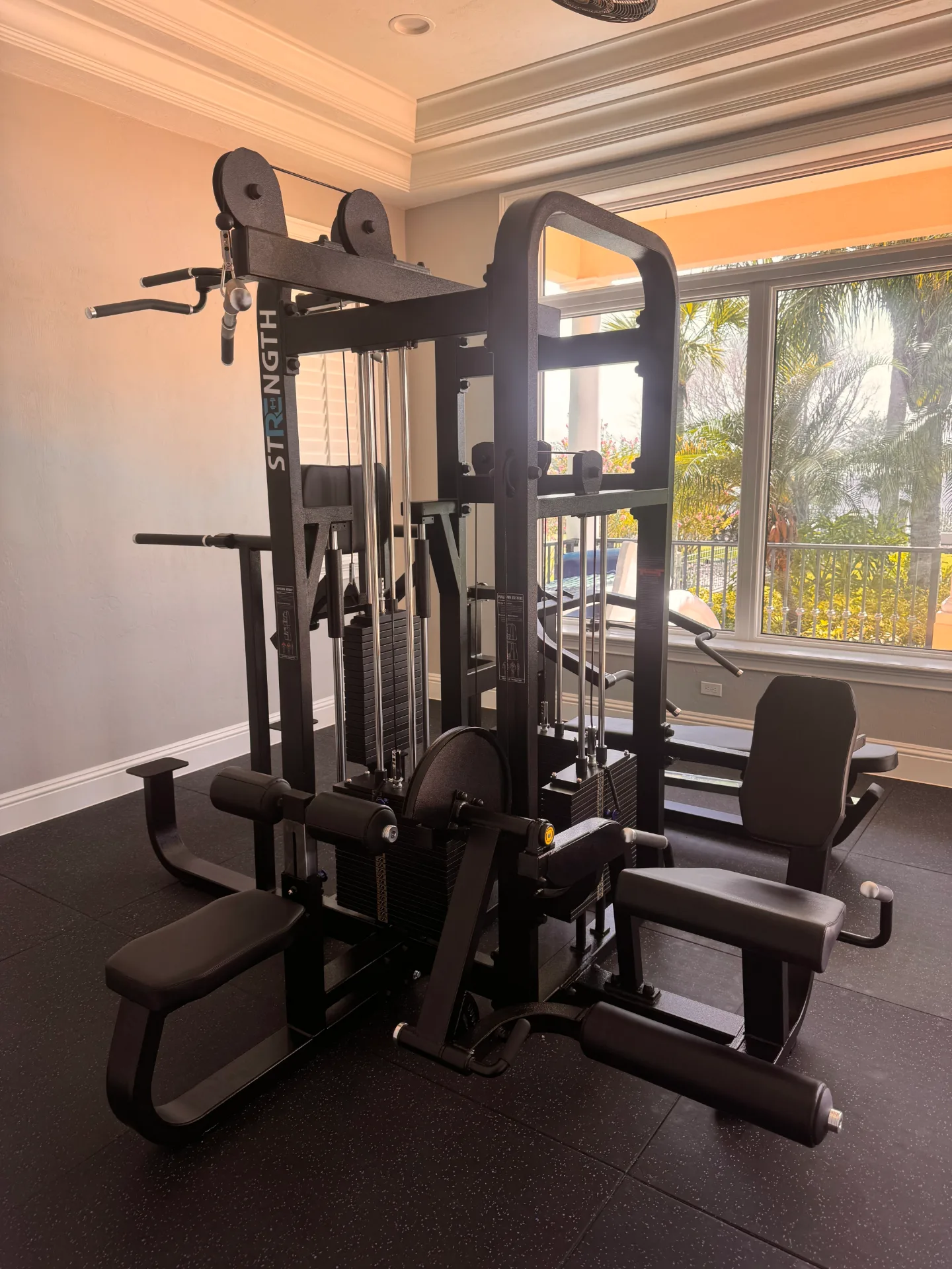 Multi-station cable weight machine in bright gym
