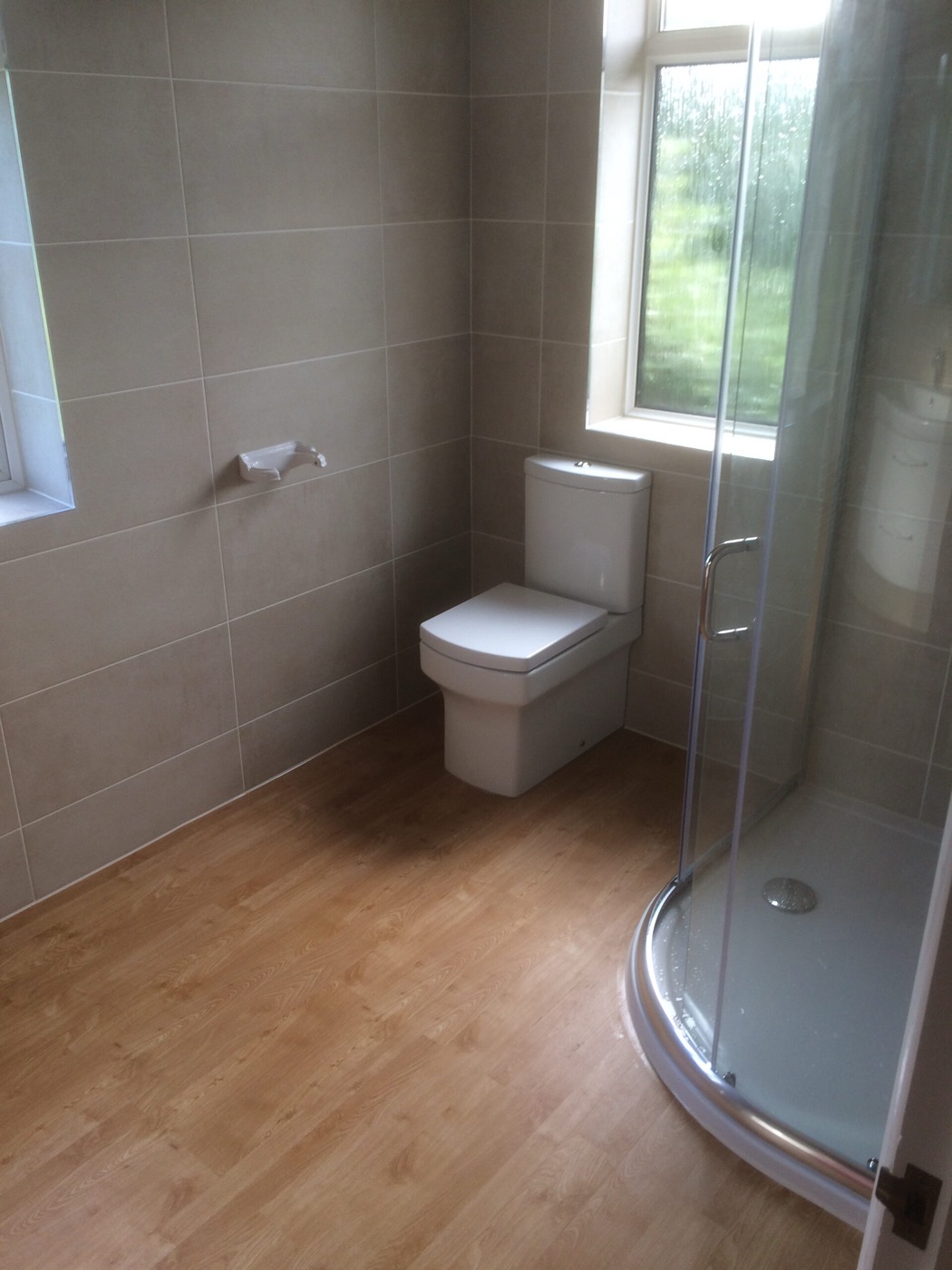 Compact walk-in shower room with light tiling