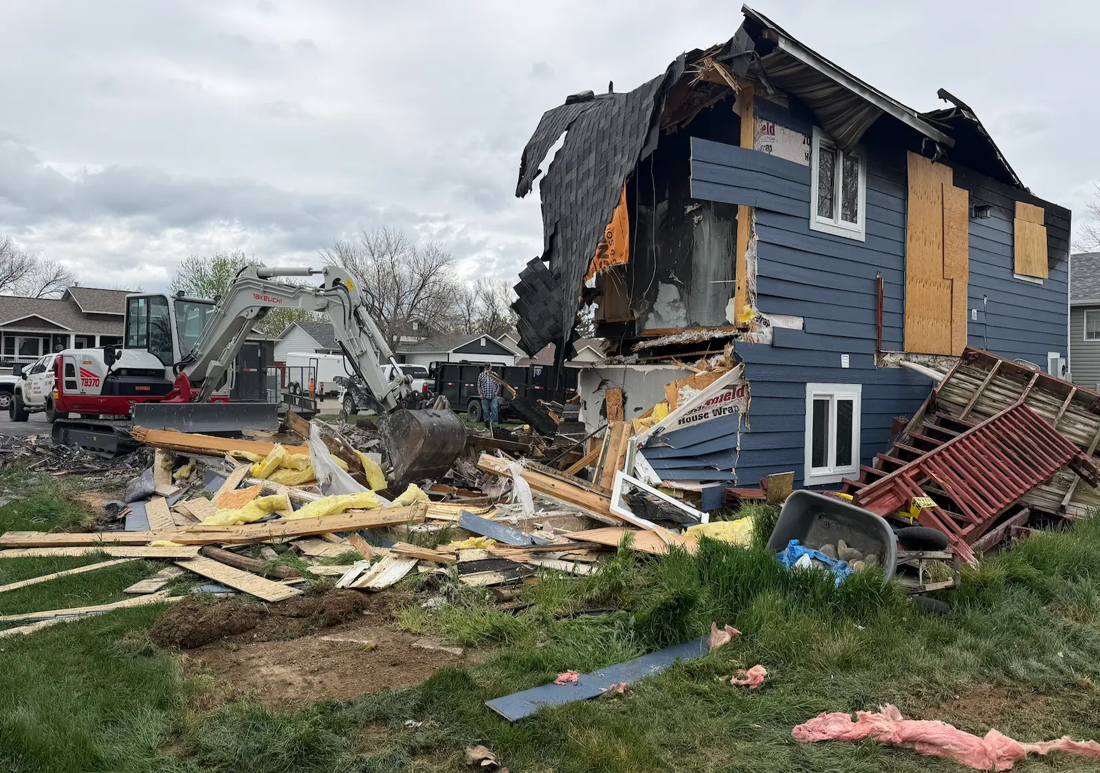 Full structure demolition Billings MT — excavator tearing down residential building