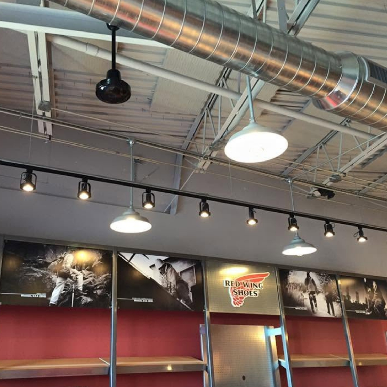 Commercial interior with overhead track and pendant lighting