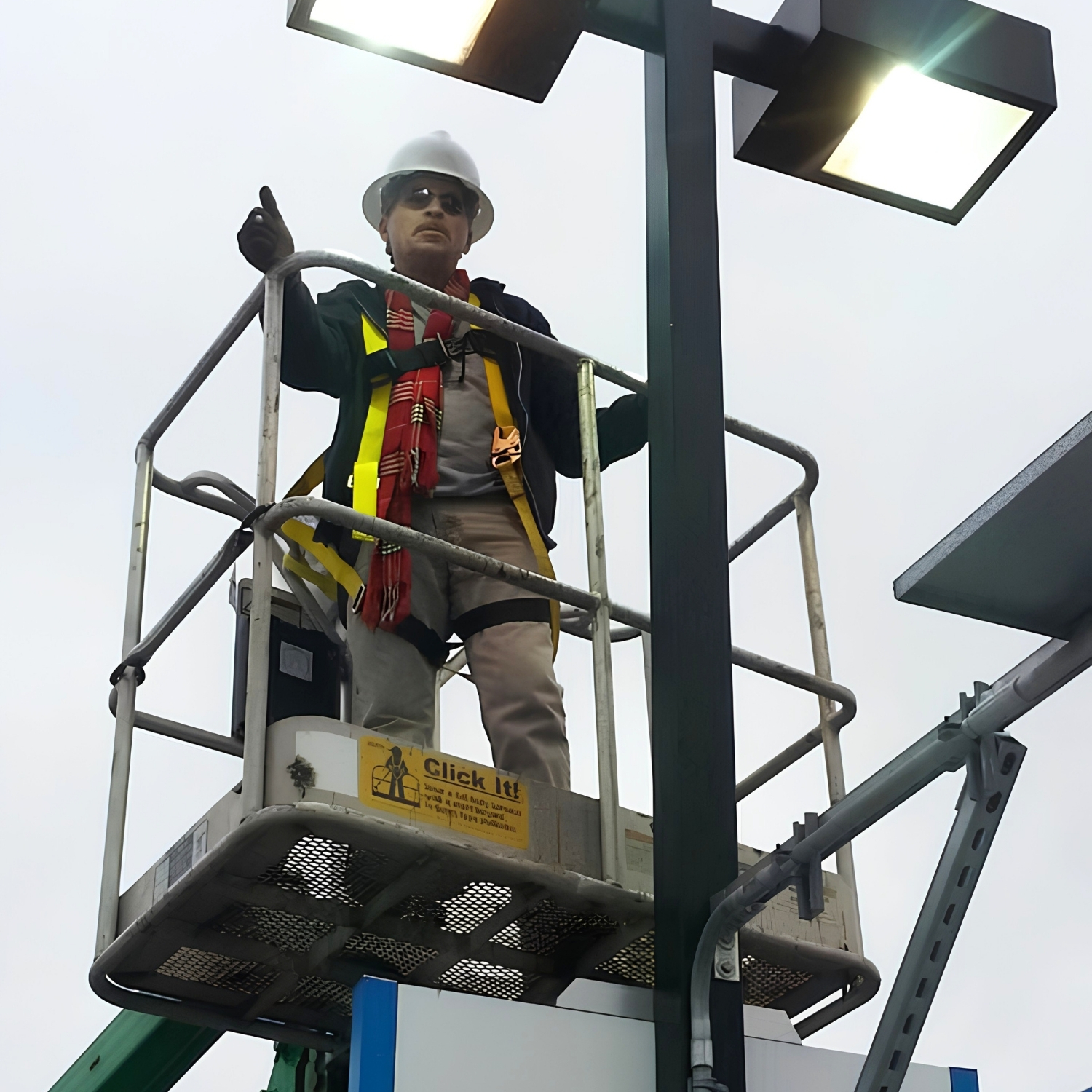 Lighthouse Electric owner working safely from a lift beside exterior lighting