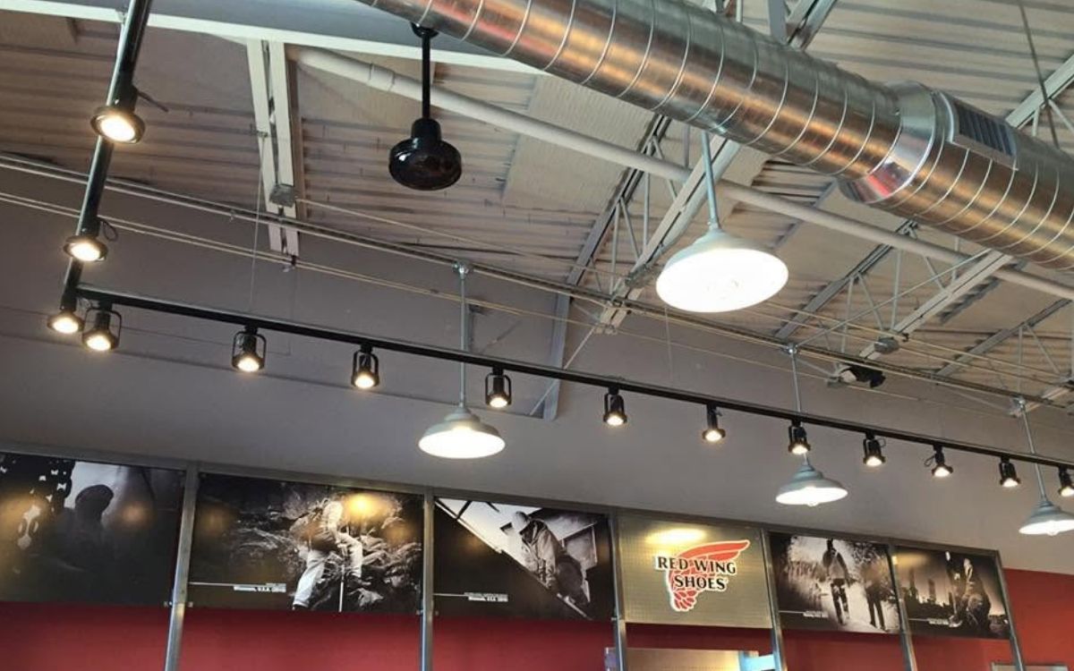 Commercial interior with overhead track and pendant lighting