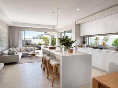 Bright open-plan Australian kitchen and living room with modern white cabinetry and neutral interiors