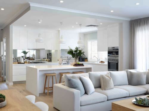Contemporary Australian open-plan kitchen and living space with white cabinetry, neutral tones, and natural light