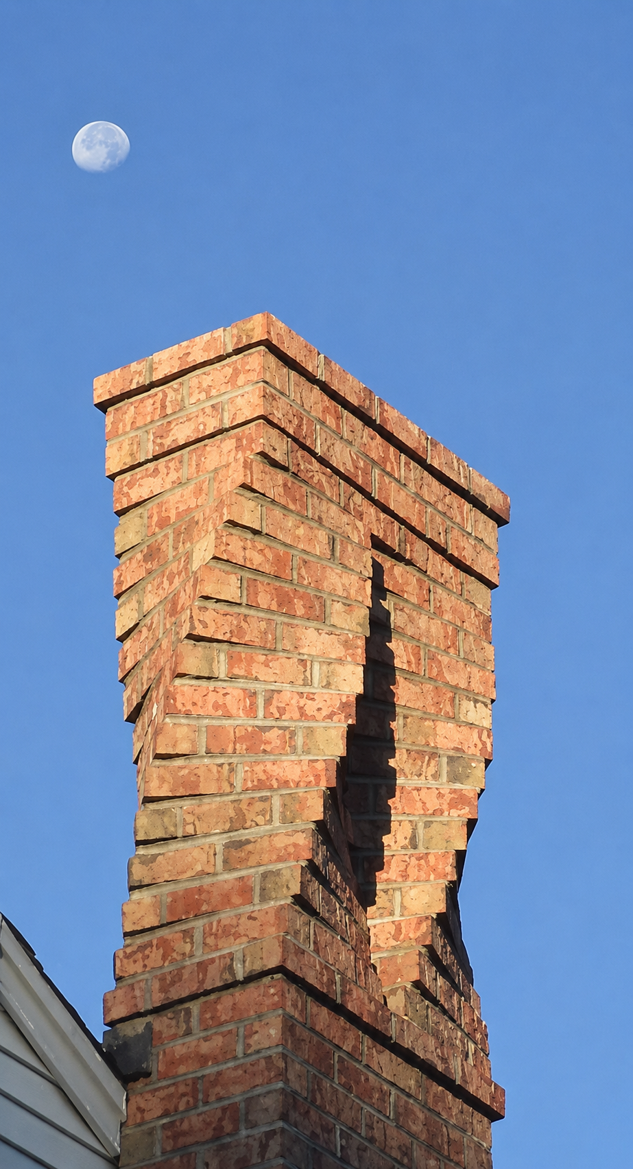 The twisted chimney — signature spiral brick masonry by Integrity Exterior Solutions