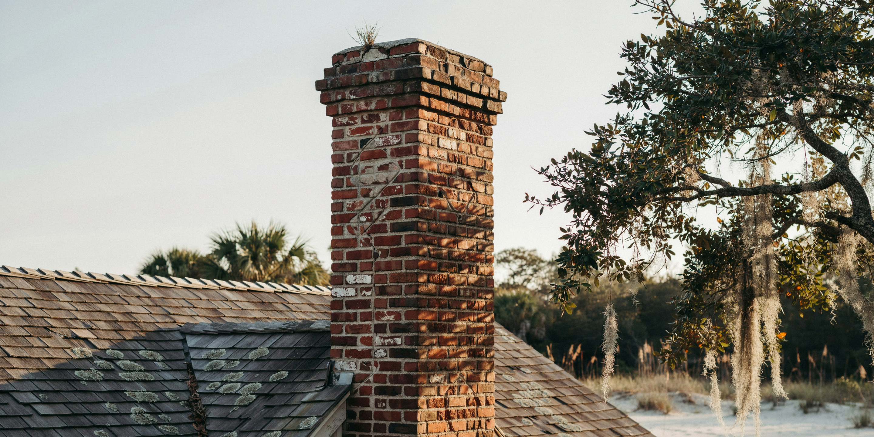Tall brick chimney showing settling
