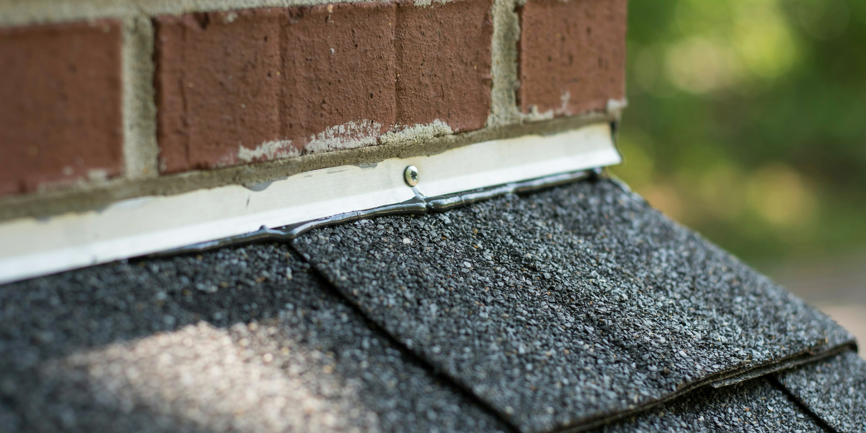 Flashing where a shingle roof meets a brick chimney