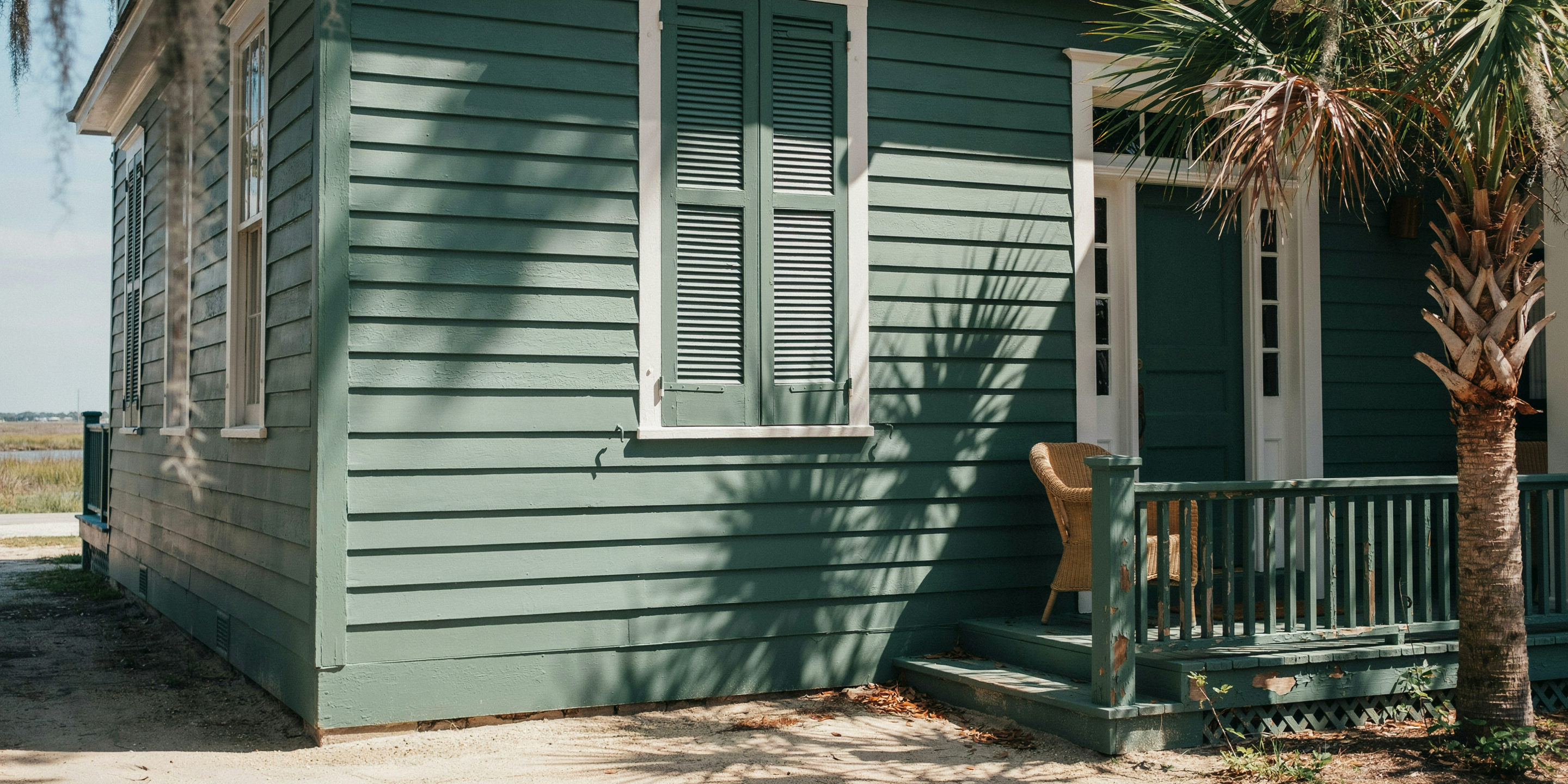 Bold-colored house exterior in bright coastal sun